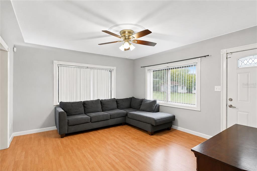 A light blue single-story house with a white fence and a small front porch — 3827 38TH AVENUE N, ST PETERSBURG, FL