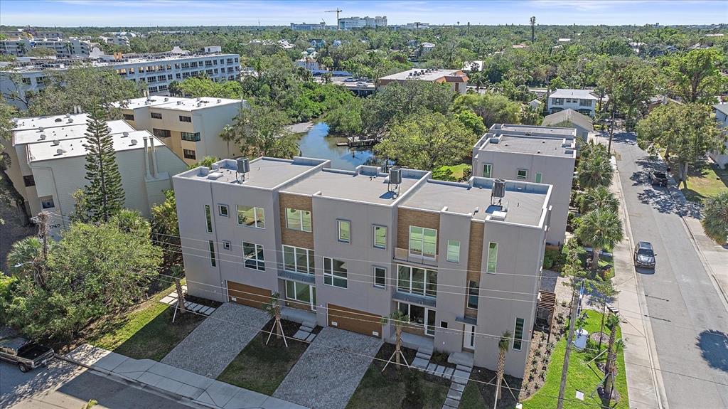An aerial view of modern multi-story townhomes with flat roofs and attached garages — 1720 ALDERMAN STREET, SARASOTA, FL
