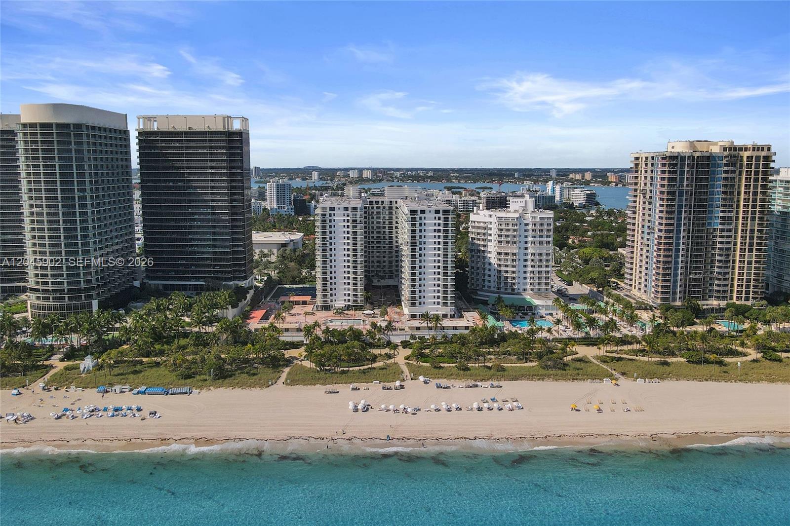 An aerial view shows high-rise residential buildings situated along a sandy beach and ocean — 9801 Collins Ave # 8S, Bal Harbour FL 33154, BAL HARBOUR, FL
