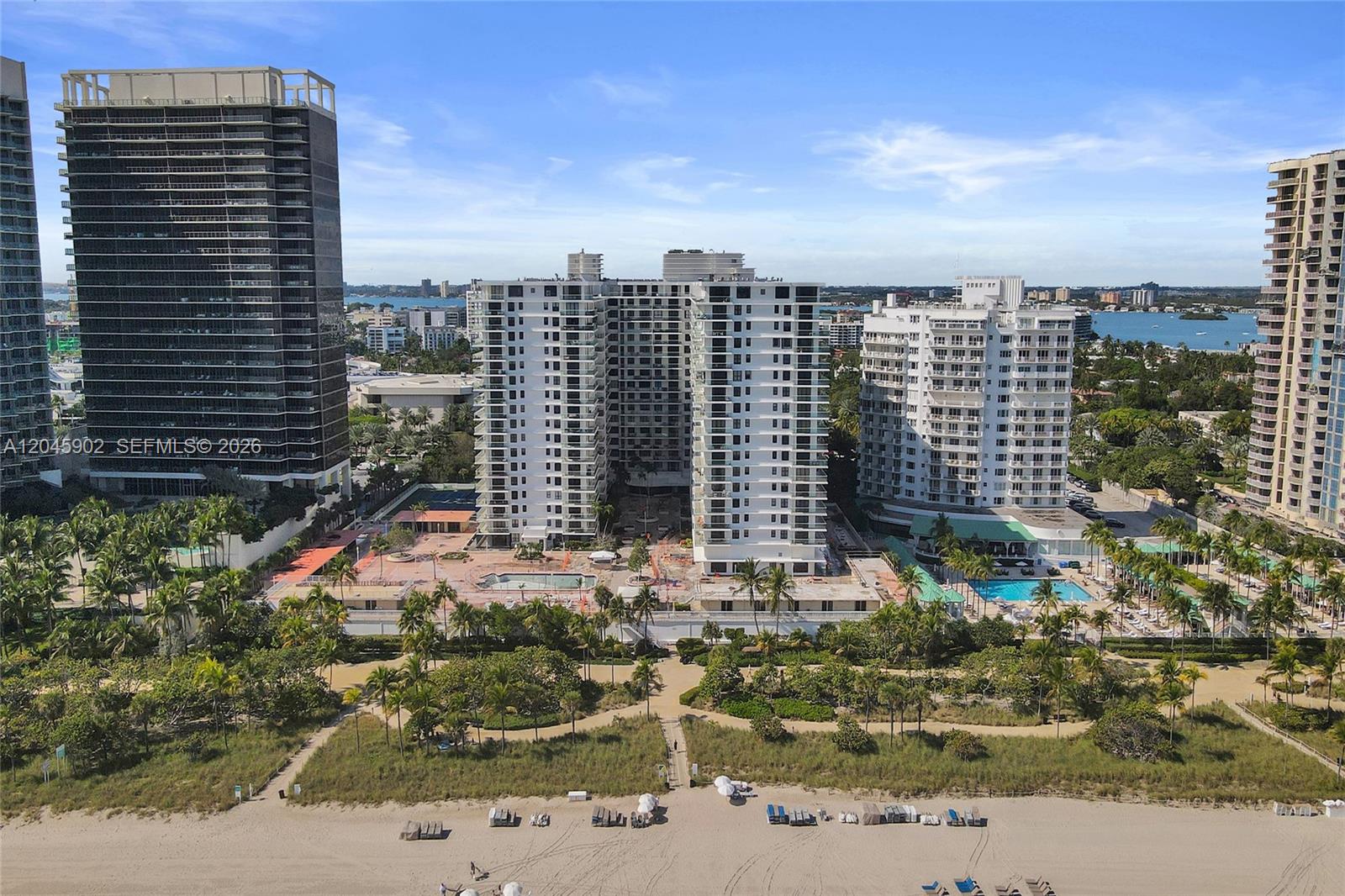 An aerial view shows several high-rise residential buildings situated along a sandy beach — 9801 Collins Ave # 8S, Bal Harbour FL 33154, BAL HARBOUR, FL