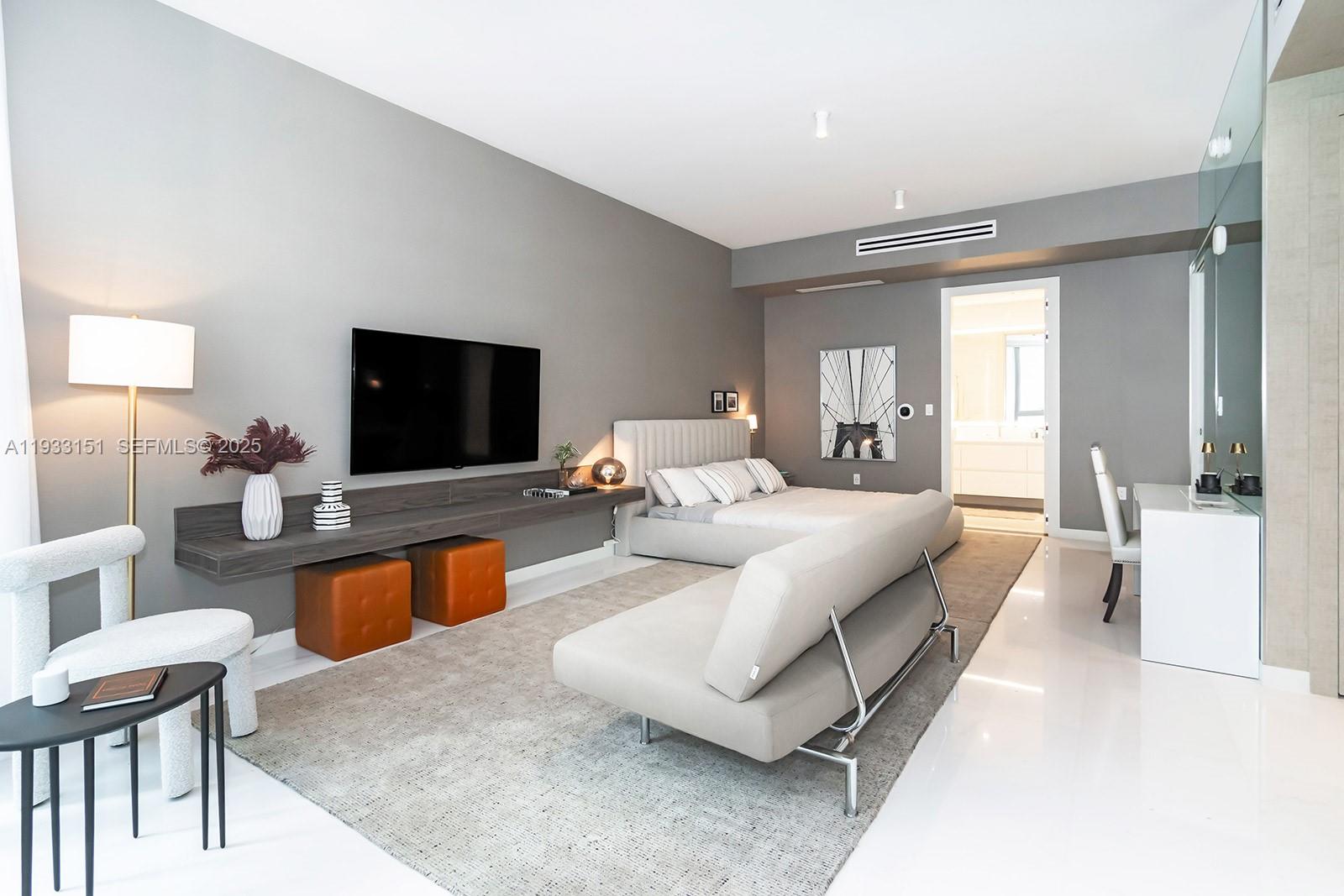A modern bedroom features a floating shelf, a bed, a sofa, and a desk area — 300 Biscayne Blvd Way # 805, Miami FL 33131, MIAMI, FL