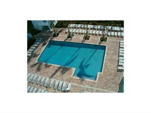 An aerial view of a rectangular swimming pool surrounded by lounge chairs on a patio — 31 SE 5th Street # 3207, Miami FL 33131, MIAMI, FL