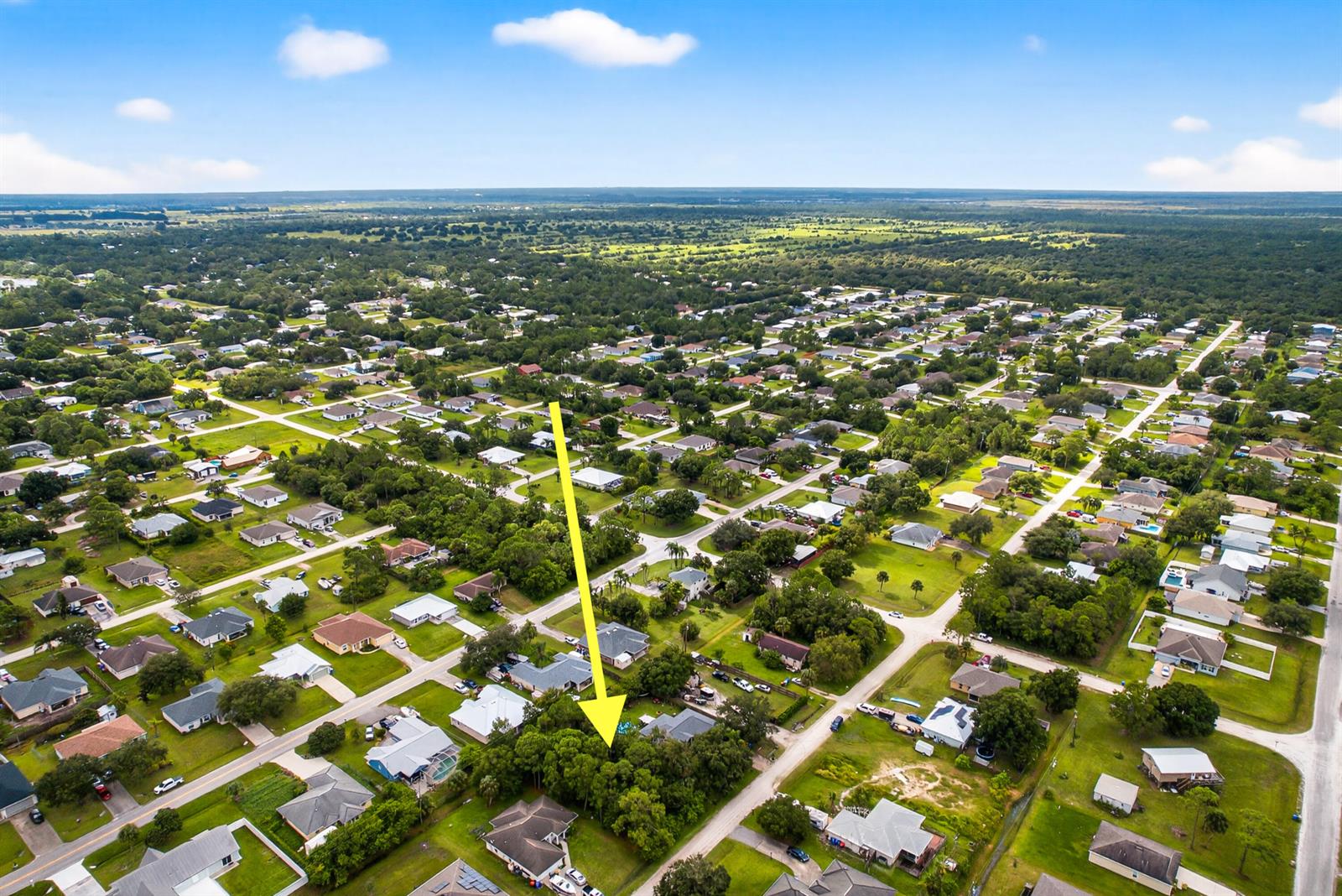 An aerial view shows a residential neighborhood with a yellow arrow pointing toward a house — 8156 101st Court, Vero Beach FL 32967, VERO BEACH, FL