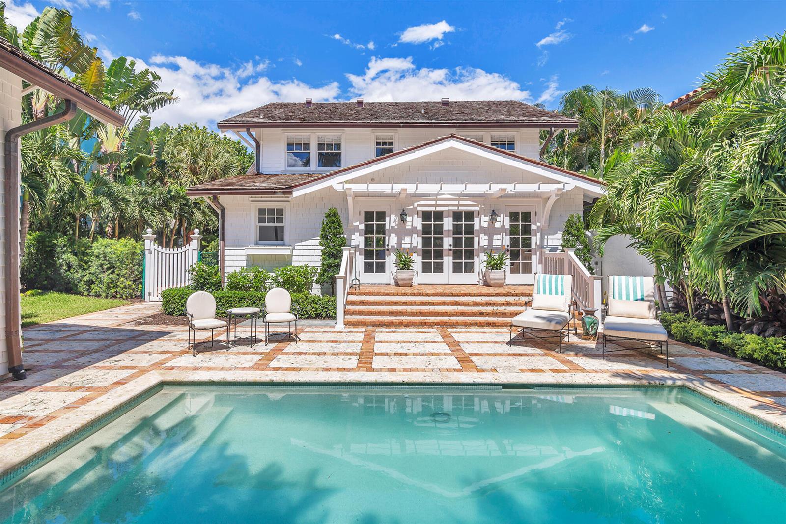 A white house with a swimming pool and a paved patio area in the backyard — 142 Seabreeze Avenue, Palm Beach FL 33480, PALM BEACH, FL