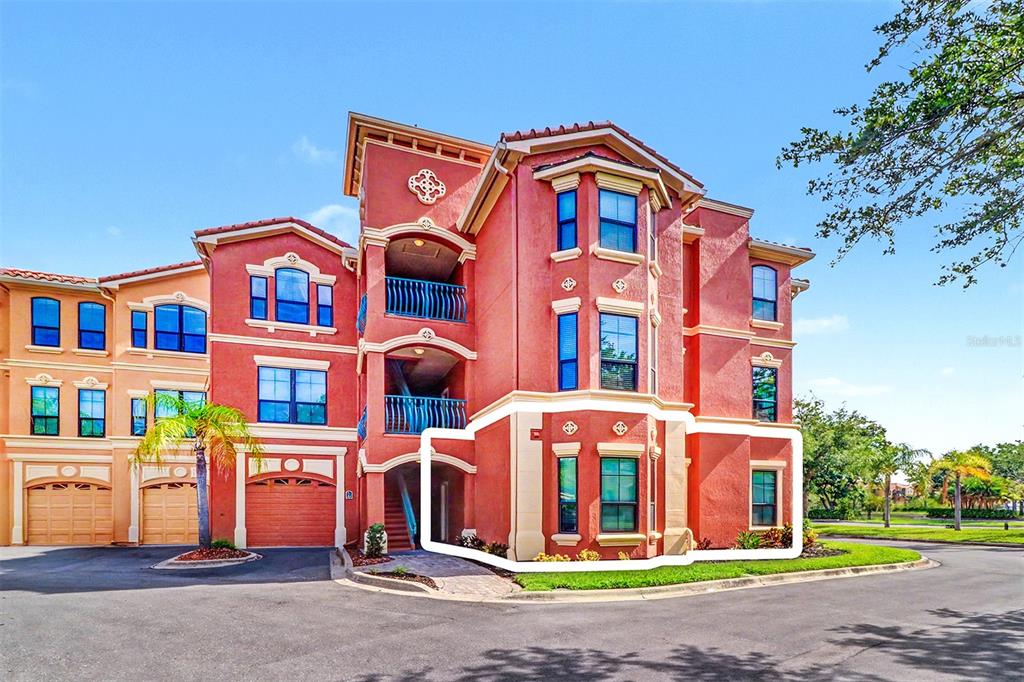 Exterior view of a multi-story residential building with a highlighted ground-floor unit — 2746 VIA TIVOLI UNIT 110B, CLEARWATER, FL