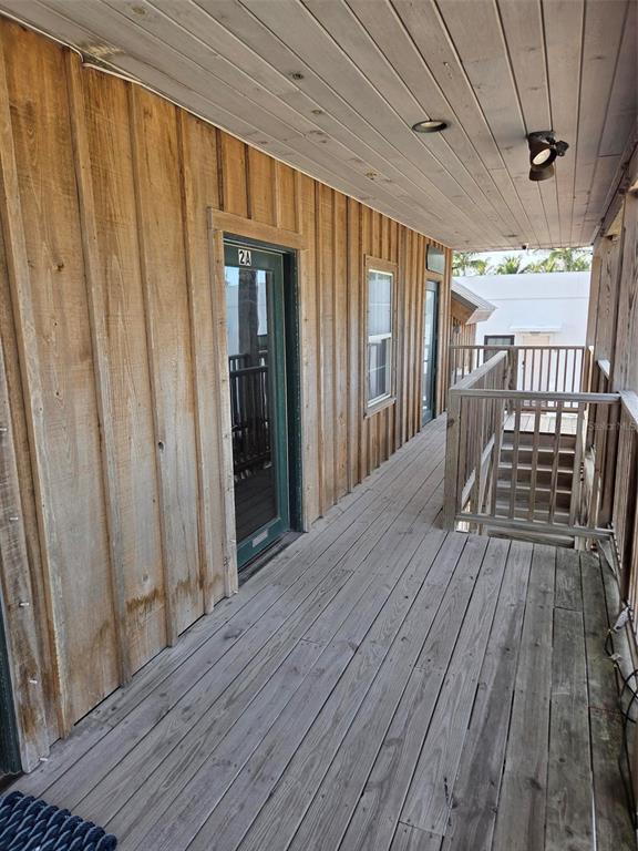 A wooden deck with vertical siding leads to a doorway marked 2A and stairs — 333 PARK AVENUE UNIT 2A, BOCA GRANDE, FL