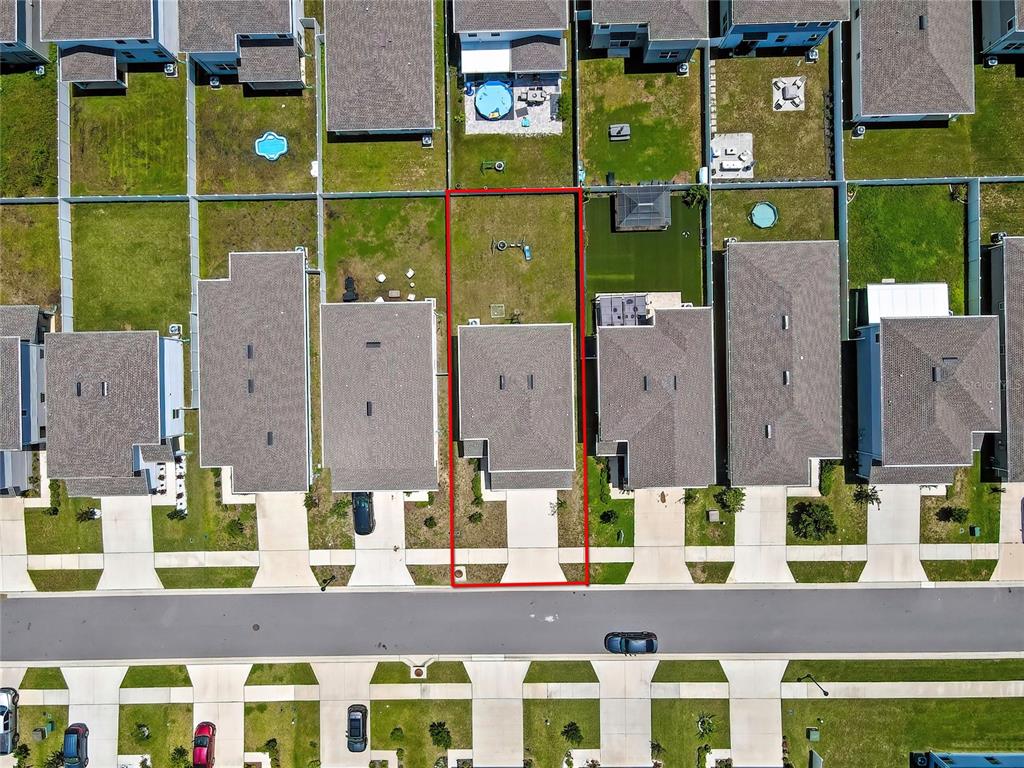 An aerial view shows a single-family home with a fenced backyard in a suburban neighborhood — 11912 THORNCREST DRIVE, SPRING HILL, FL