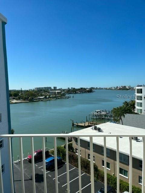 A view from a balcony overlooking a waterway, a parking lot, and nearby buildings — 285 107TH AVENUE UNIT 606, TREASURE ISLAND, FL