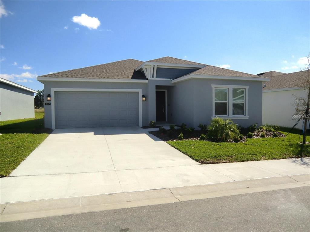 A single-story gray house with a two-car garage and a concrete driveway — 317 LOCH COURT, DAVENPORT, FL