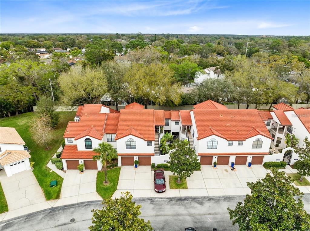 An aerial view shows a multi-unit townhouse complex with red tile roofs and driveways — 550 VIA DEL ORO DRIVE UNIT 102, ALTAMONTE SPRINGS, FL