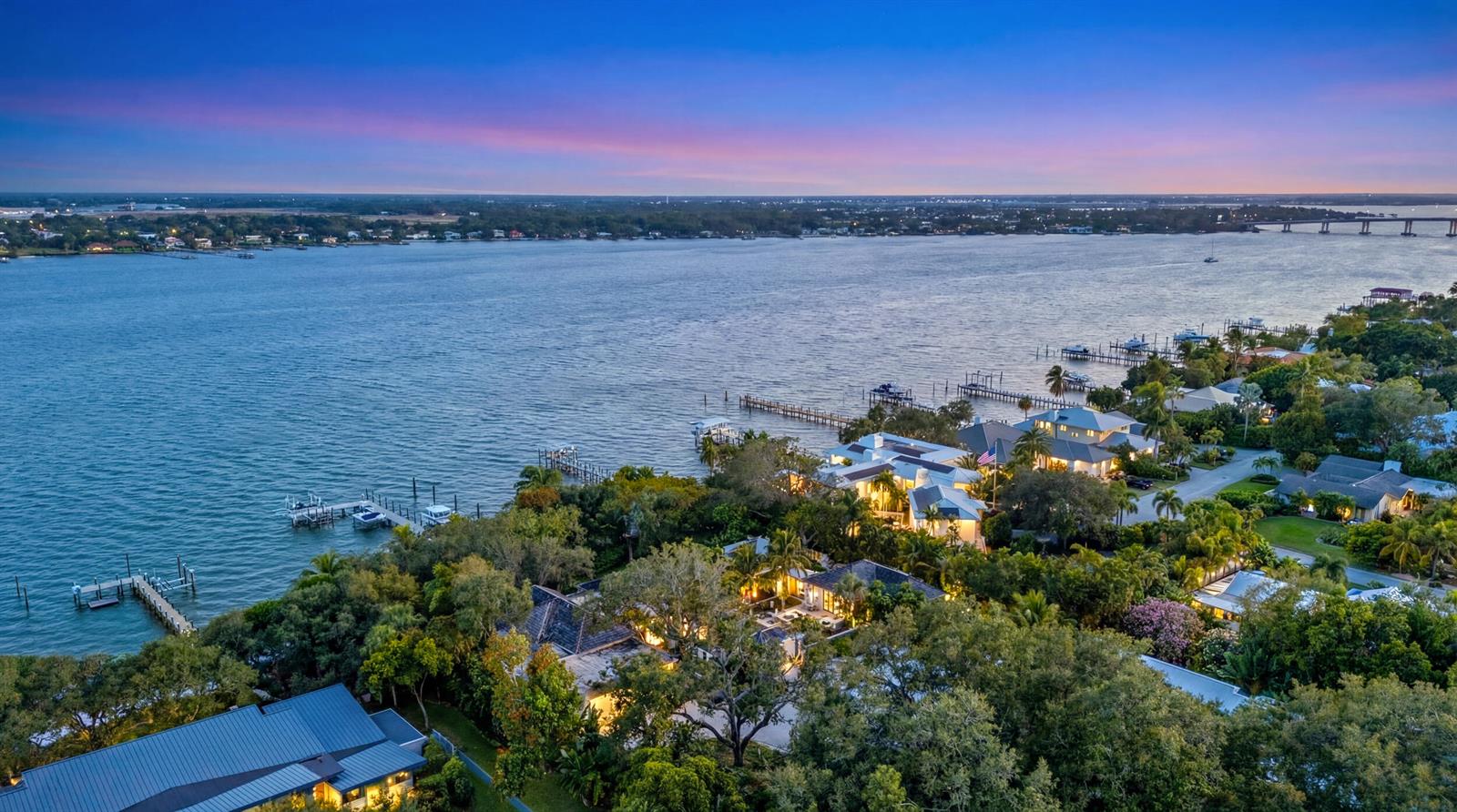 An aerial view of waterfront homes surrounded by lush trees at sunset — 109 S River Road, Sewalls Point FL 34996, SEWALLS POINT, FL