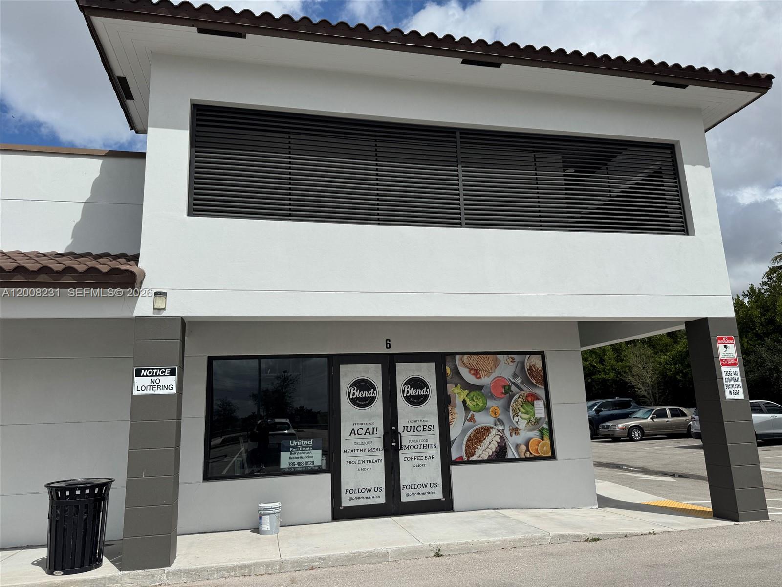A two-story commercial building features a ground-level storefront with a glass entrance and signage — 15535 SW 120th ST # 6, Miami FL 33196, MIAMI, FL