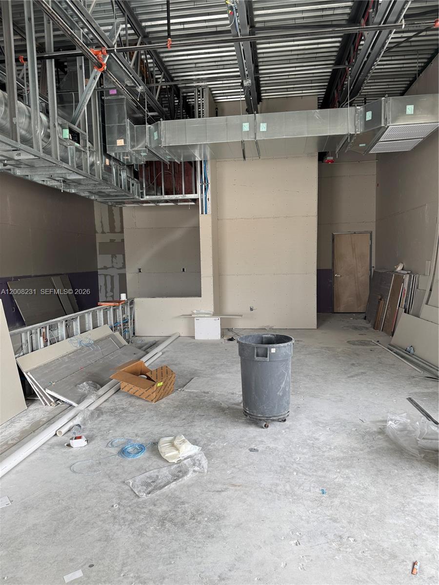 An unfinished commercial interior features exposed ceiling ductwork, metal framing, and drywall installation — 15535 SW 120th ST # 6, Miami FL 33196, MIAMI, FL
