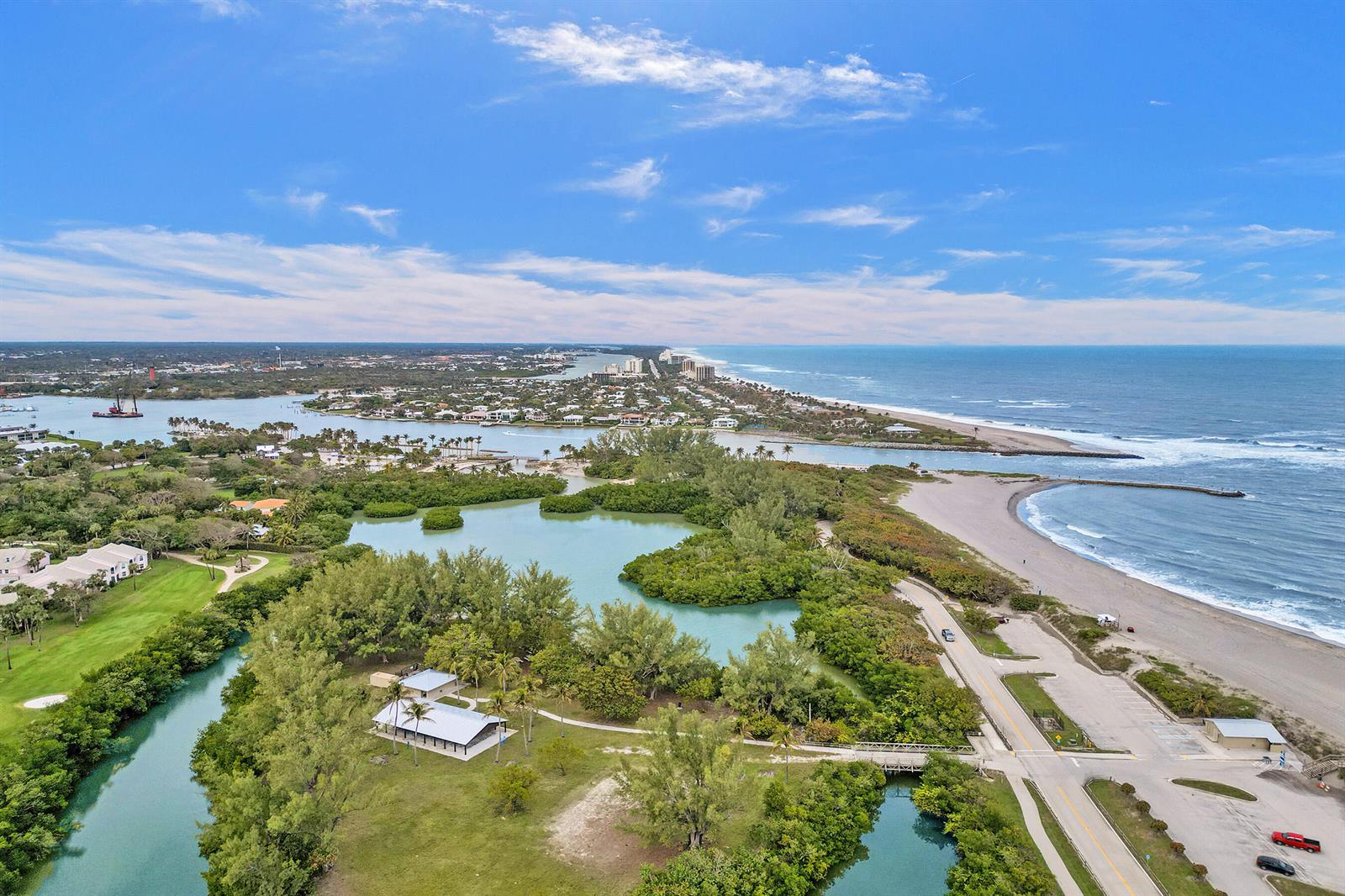 An aerial view shows a coastal park with a lagoon, beach, and inlet — 400 Ocean Trail Way # 308, Jupiter FL 33477, JUPITER, FL
