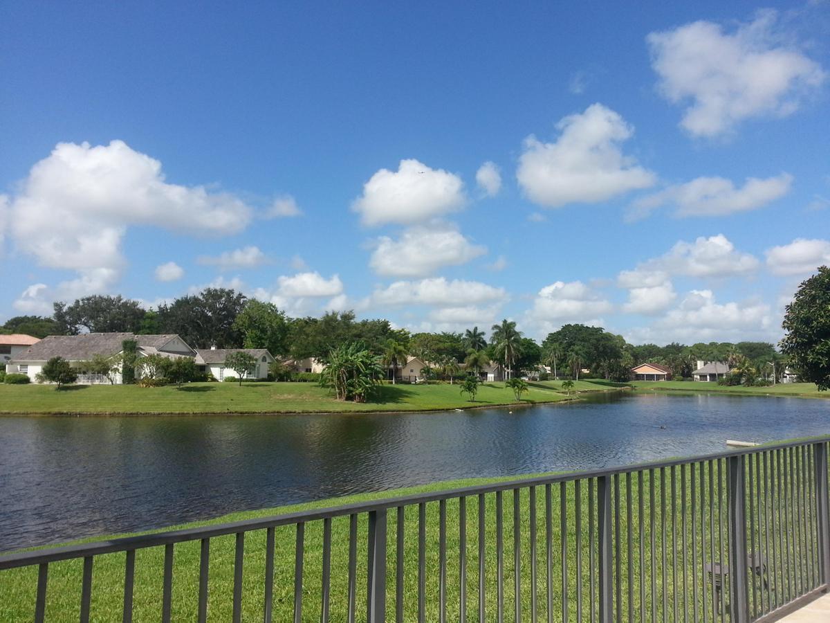 A view of a lake and houses from behind a metal railing — 4020 NW 24th Ter Terrace, Boca Raton FL 33431, BOCA RATON, FL