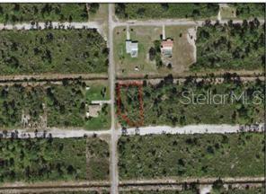 An aerial view shows a vacant, rectangular lot outlined in red along a dirt road — 0 HIBISCUS DRIVE, INDIAN LAKE ESTATES, FL