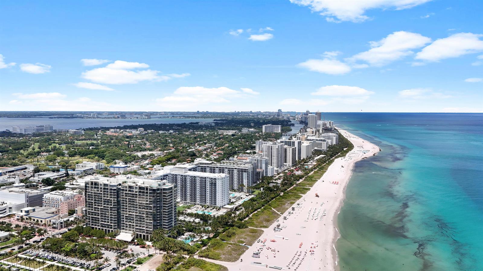 An aerial view of a sandy beach lined with high-rise apartment buildings and ocean water — 8956 Collins Avenue # 4, Surfside FL 33154, SURFSIDE, FL