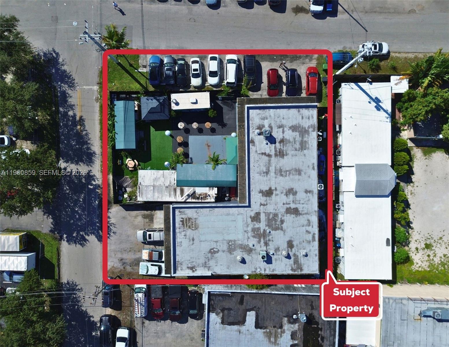 An aerial view shows a commercial building with a parking lot and outdoor patio area — 2220 SW 60th Ter, Miramar FL 33023, MIRAMAR, FL