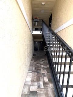 An outdoor walkway with stone pavers leads to a staircase with black metal railings — 900 LAKE DESTINY ROAD UNIT B, ALTAMONTE SPRINGS, FL