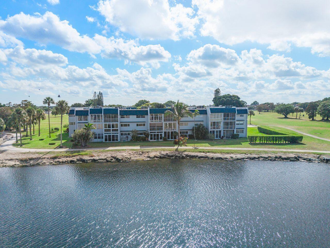 An aerial view of a multi-story apartment building situated along a waterfront and golf course — 7807 Golf Cir Drive # 308, Margate FL 33063, MARGATE, FL