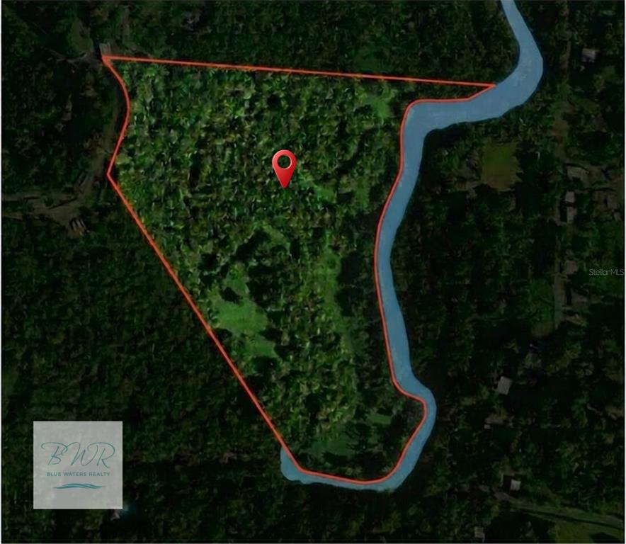 An aerial map shows a wooded plot of land bordered by a river on one side — KM 22.1 PR 186, RIO GRANDE, PR