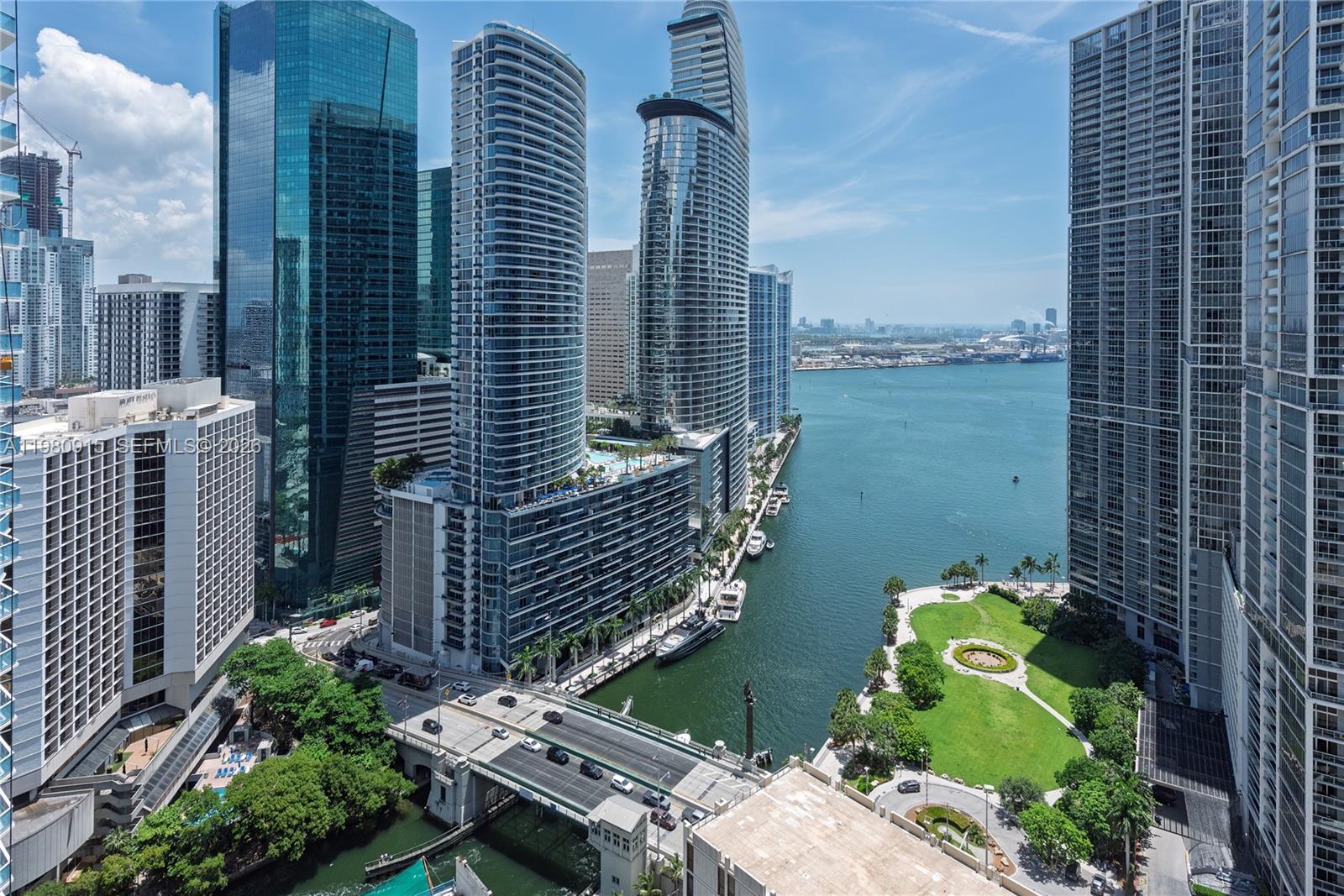 An elevated view of a Miami waterfront featuring modern skyscrapers, a bridge, and a park — 77 SE 5th Street # 3204, Miami FL 33131, MIAMI, FL