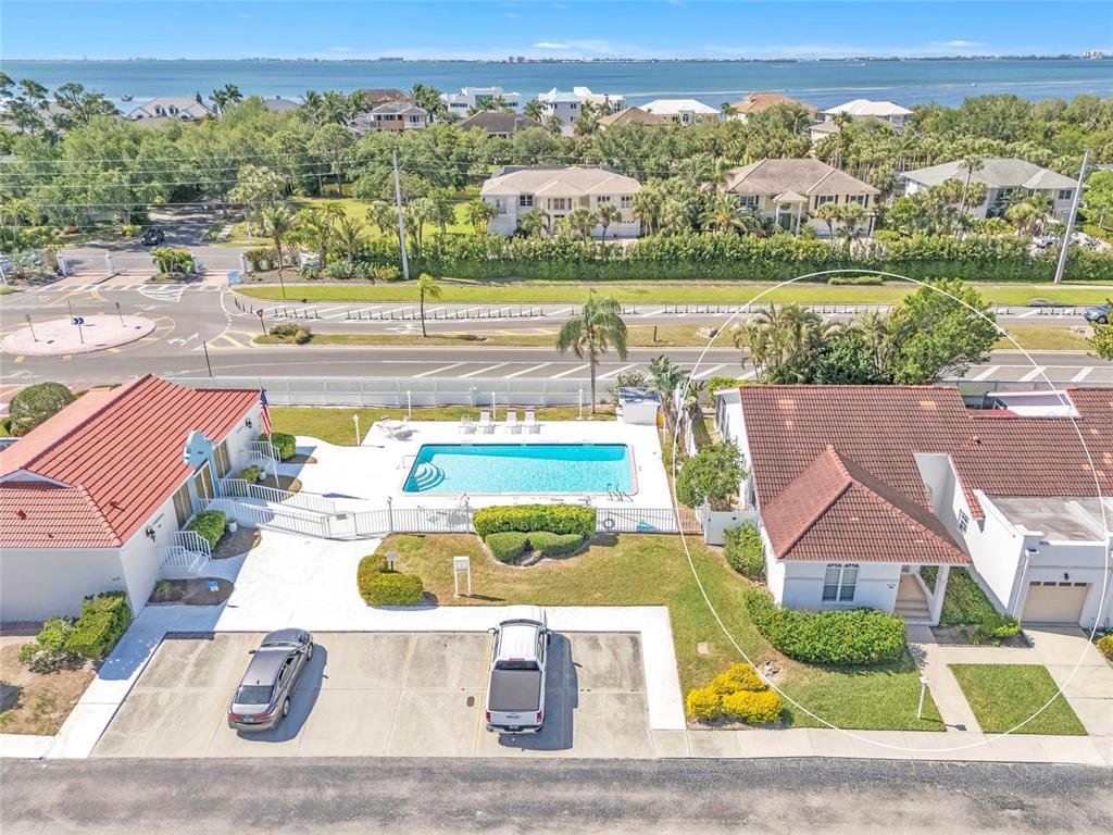 An aerial view shows two adjacent houses with red tile roofs and a shared pool — 4808 61ST AVENUE TERRACE W, BRADENTON, FL