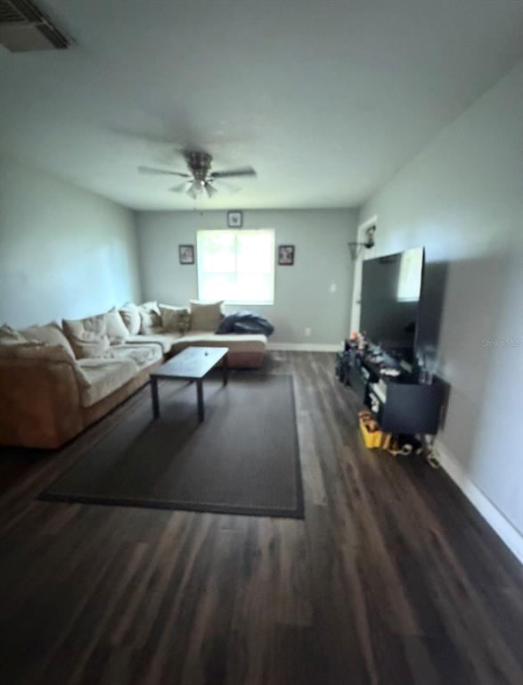 A living room features a large sectional sofa, a coffee table, and a television console — 231 BERRY TREE PLACE, BRANDON, FL
