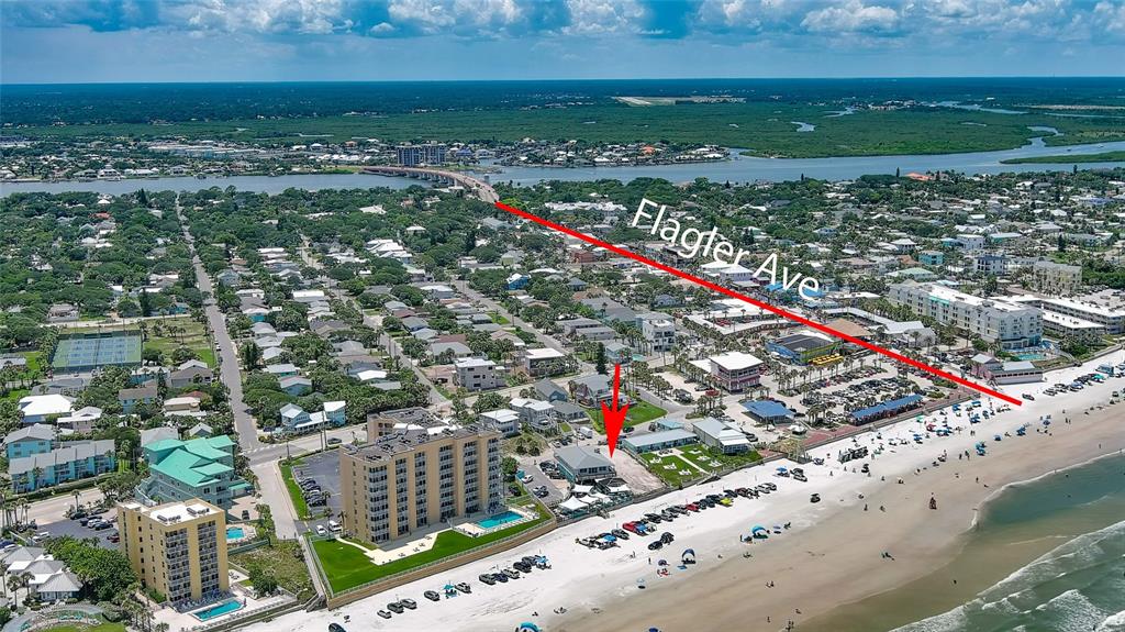 An aerial view shows a beachside property with a red arrow pointing toward a building — 0 BUENOS AIRES AVENUE, NEW SMYRNA BEACH, FL