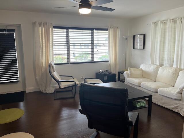 A living room features dark wood floors, a white sofa, and a ceiling fan — 123 Kent # H, West Palm Beach FL 33417, WEST PALM BEACH, FL
