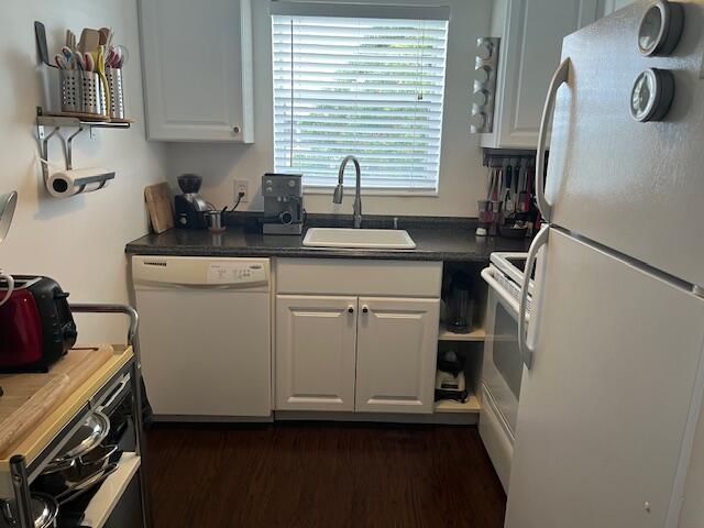 A small kitchen features white cabinets, a dishwasher, a sink, and white appliances — 123 Kent # H, West Palm Beach FL 33417, WEST PALM BEACH, FL