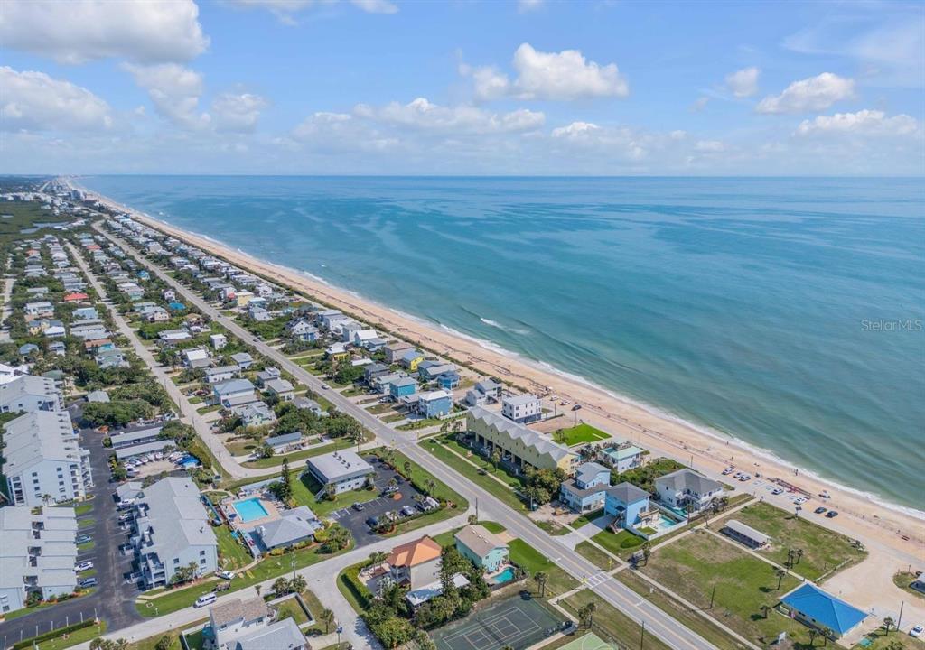 An aerial view of a coastal neighborhood featuring houses, a beach, and the ocean — 6608 S ATLANTIC AVENUE, NEW SMYRNA BEACH, FL