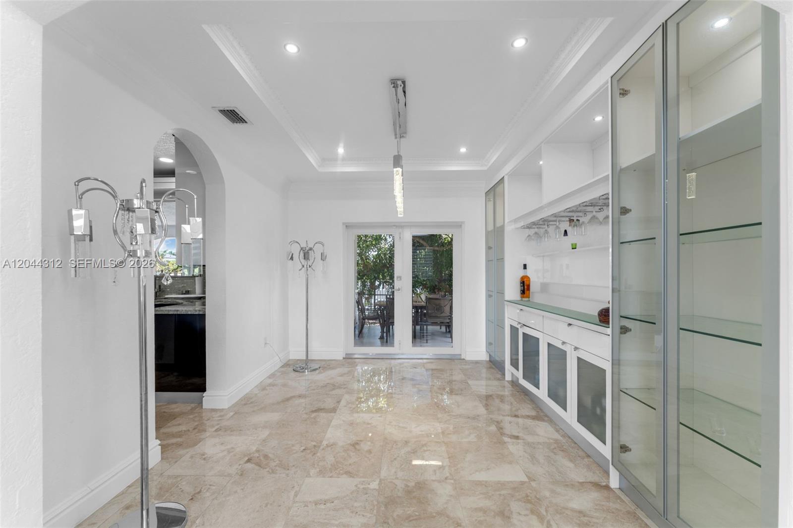 A bright dining area features marble floors, a built-in bar, and glass-paned double doors — 15262 SW 11th St, Miami FL 33194, MIAMI, FL