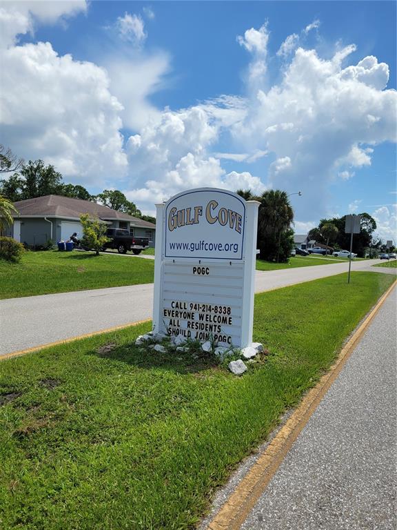 A sign for Gulf Cove stands on a grassy roadside near a residential house — 5054 CANNON STREET, PORT CHARLOTTE, FL
