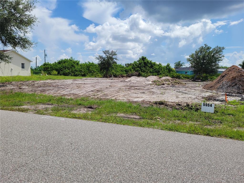A vacant, cleared residential lot with a small sign and piles of dirt — 5054 CANNON STREET, PORT CHARLOTTE, FL
