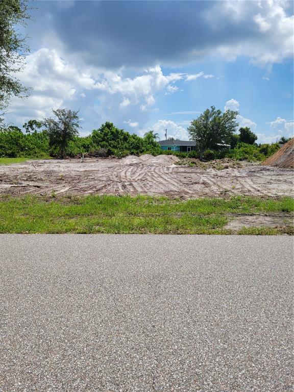 A vacant, cleared residential lot with tire tracks in the dirt and surrounding trees — 5054 CANNON STREET, PORT CHARLOTTE, FL