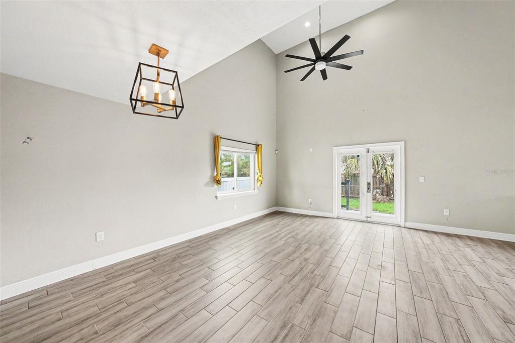 A bathroom features a white vanity with gold fixtures, a toilet, and a marble-tiled tub — 2619 W ST CONRAD, TAMPA, FL