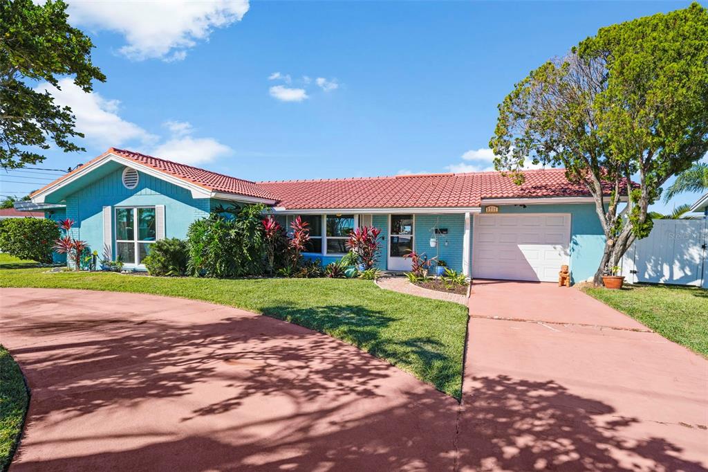 A single-story blue house with a red roof and a curved red driveway — 3711 FLORAMAR TERRACE, NEW PORT RICHEY, FL