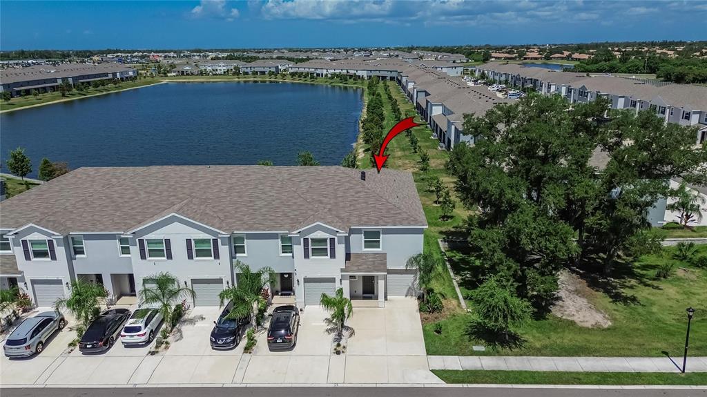 An aerial view shows a multi-unit townhouse building with a gray roof and attached garages — 331 MANGROVE SHADE CIRCLE, APOLLO BEACH, FL