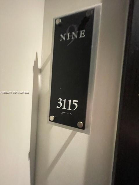 A black rectangular sign with the word NINE and the number 3115 mounted on a wall — 999 SW 1st Ave # 3115, Miami FL 33130, MIAMI, FL