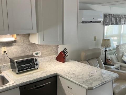 A kitchen with gray cabinets, a marble-patterned countertop, and a toaster oven on the counter — 800 CHESAPEAKE DRIVE UNIT 42, TARPON SPRINGS, FL
