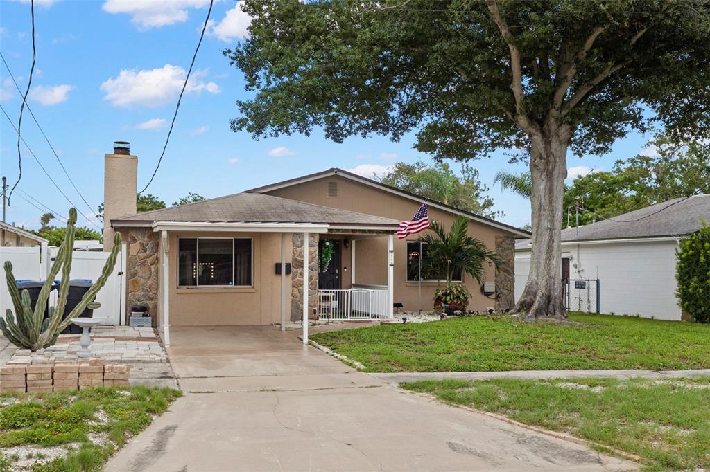 An aerial view shows a single-story house with a backyard swimming pool and surrounding neighborhood — 5210 6TH STREET S, ST PETERSBURG, FL
