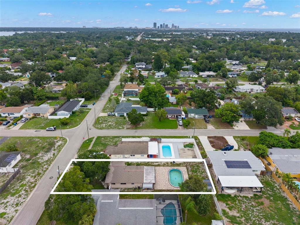A single-story house with a carport, stone accents, and a large tree in the front yard — 5210 6TH STREET S, ST PETERSBURG, FL