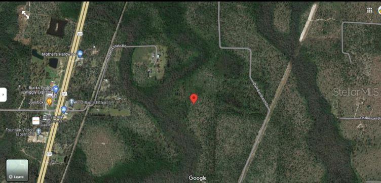 This is a satellite map view showing a wooded lot marked with a red pin — N/A, FOUNTAIN, FL