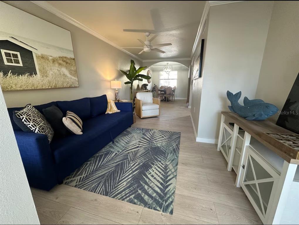 A white front door with a keypad lock is set into a light blue exterior wall — 19417 GULF BOULEVARD UNIT F110, INDIAN ROCKS BEACH, FL