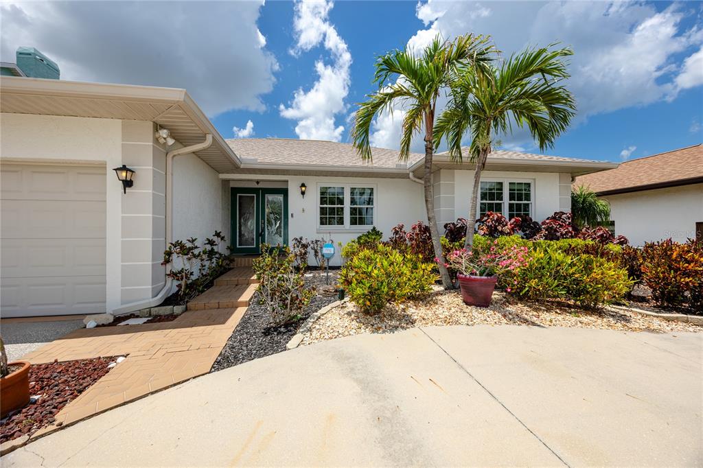 A single-story house with a white exterior, a garage, and a landscaped front yard — 1116 KINGFISH PLACE, APOLLO BEACH, FL