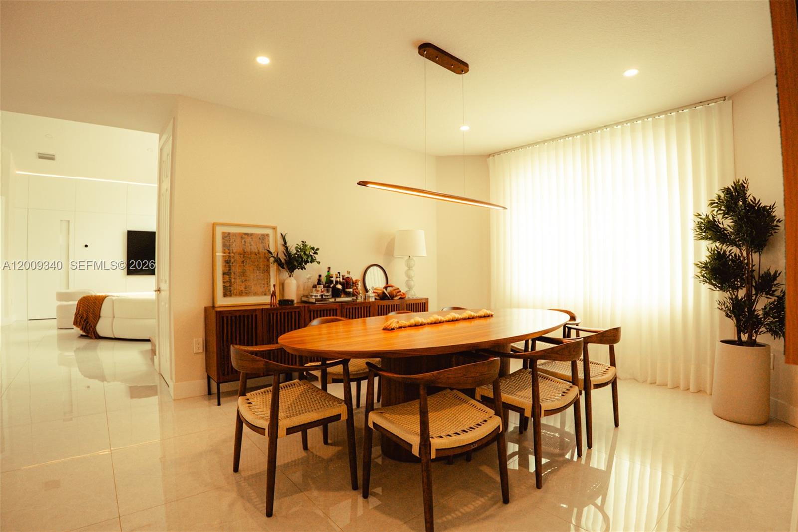 A dining room features a wooden oval table, six chairs, and a modern pendant light — 3761 SW 144th Ave, Miramar FL 33027, MIRAMAR, FL
