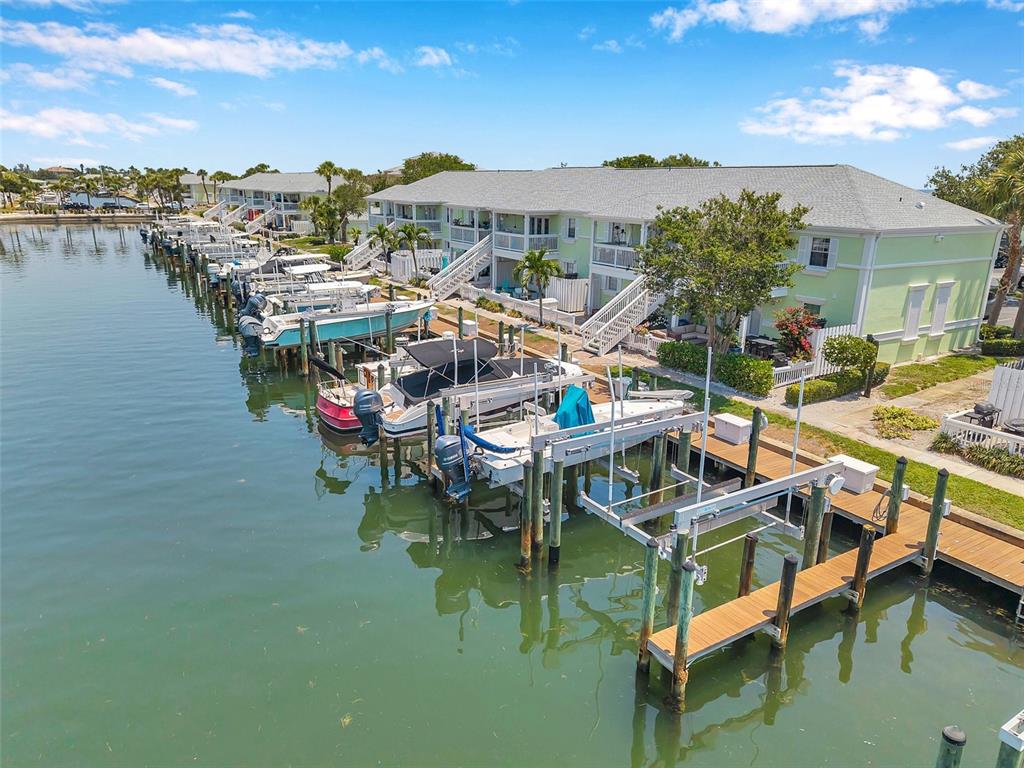 An aerial view shows a multi-unit residential building with a private boat dock and slips — 0 #114SS COQUINA KEY DRIVE SE UNIT 114SS, ST PETERSBURG, FL