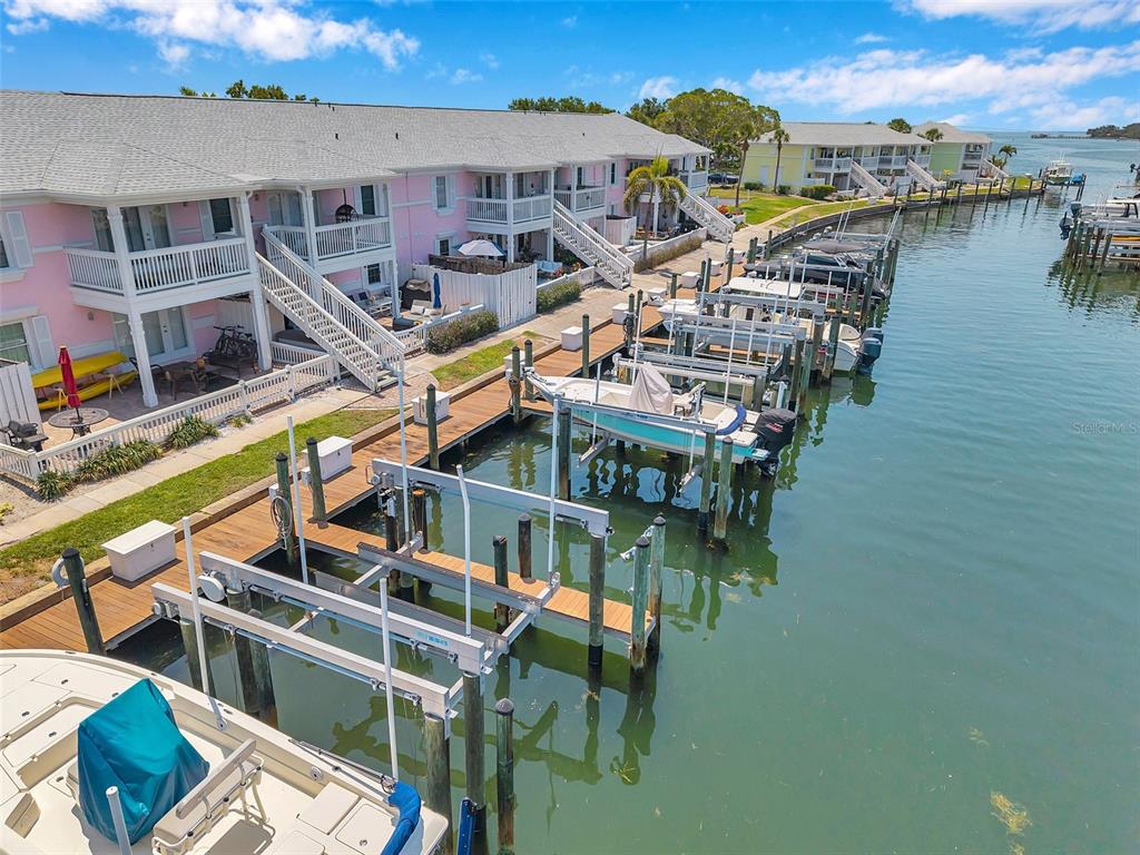 An aerial view shows pink waterfront townhomes with private boat slips and docks — 0 #114SS COQUINA KEY DRIVE SE UNIT 114SS, ST PETERSBURG, FL