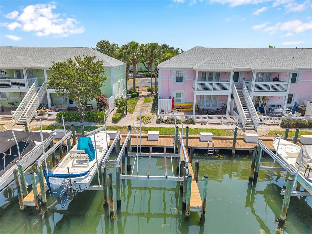 An aerial view shows two pastel-colored waterfront townhouses with private boat slips and docks — 0 #114SS COQUINA KEY DRIVE SE UNIT 114SS, ST PETERSBURG, FL